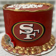 Red cake with a San Francisco logo and Happy Birthday text.