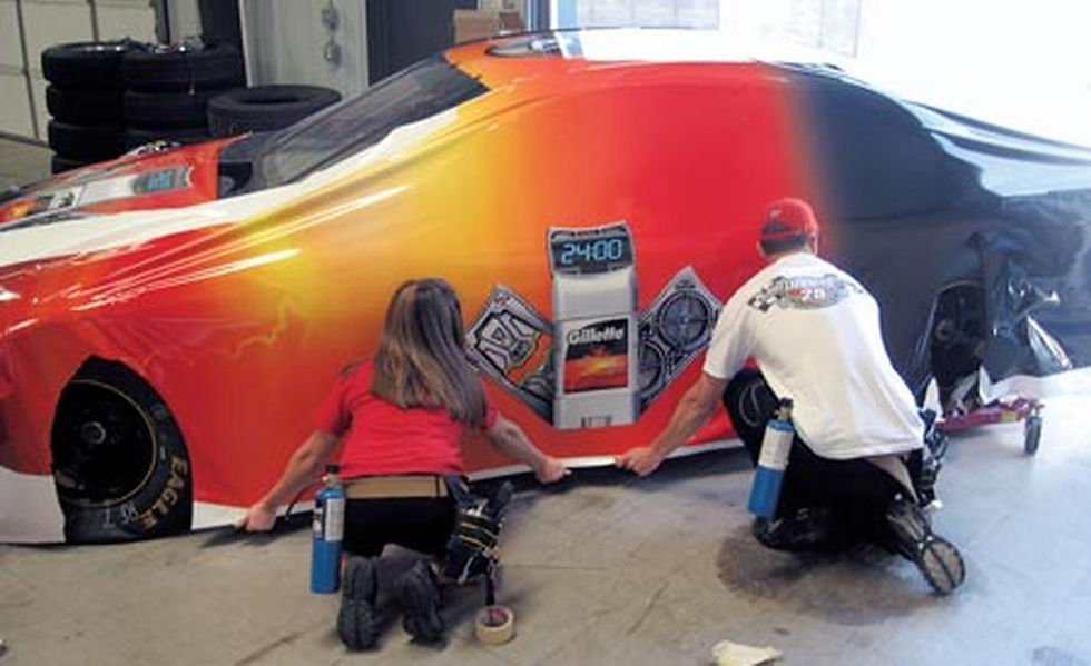 kelly-tart-left-and-ryan-davidson-installers-for-motorsports-designs-align-the-bottom-of-a-side-pane