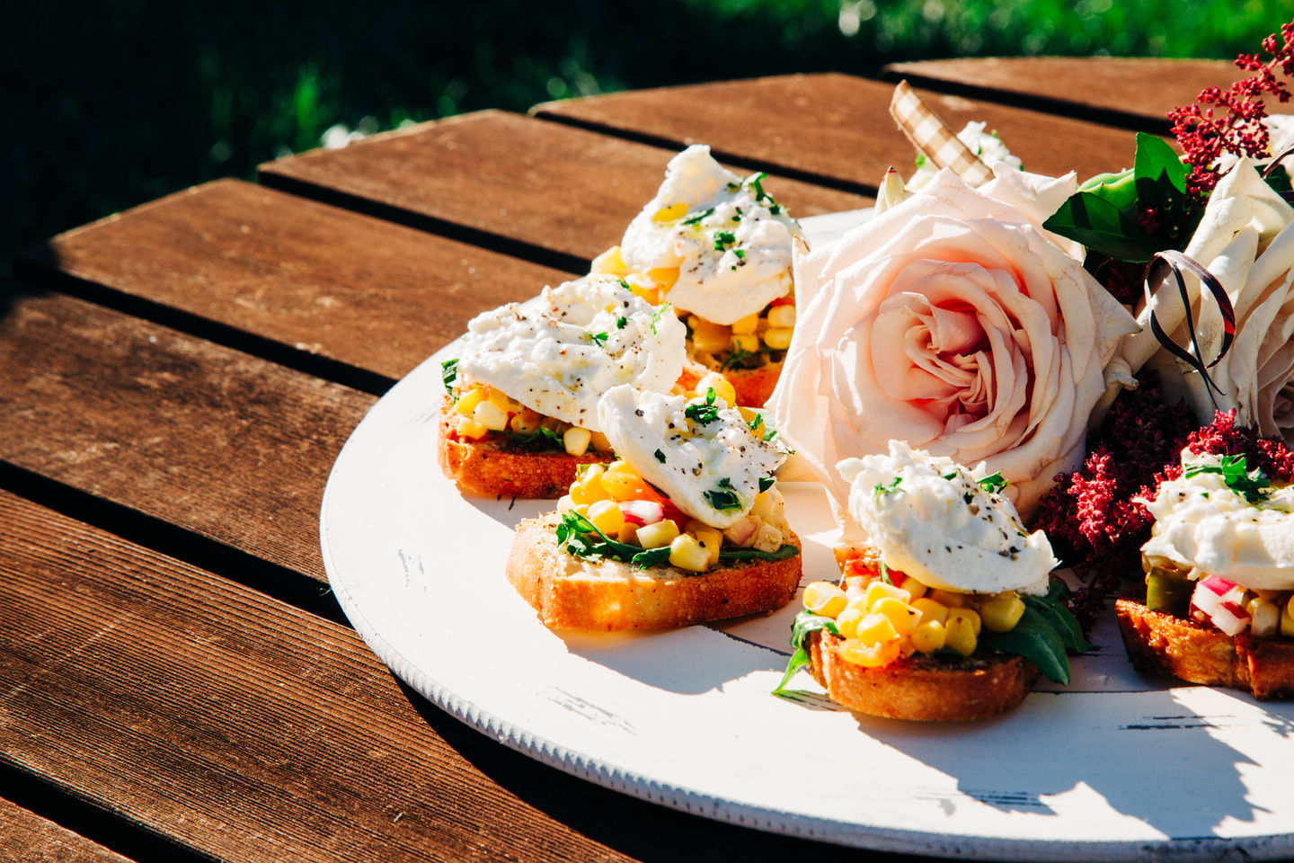 Crostini appetizers topped with whipped cheese and flowers at a wedding catered by Tia’s Food of Love.