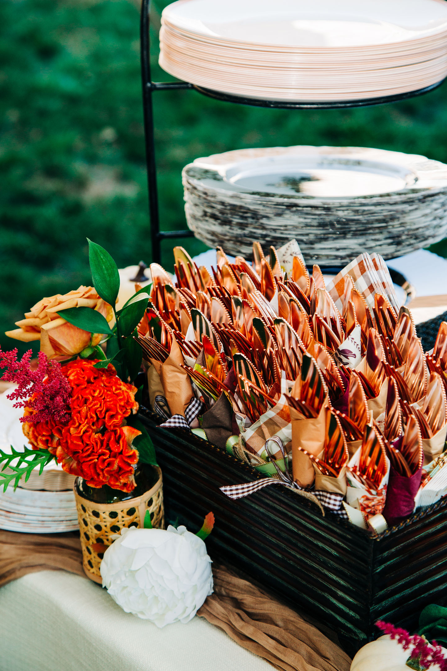 Wedding cutlery and plate setup with floral decorations by Tia’s Food of Love.