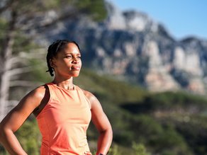 Shot of a young African woman taking a break while out for a trail run to reach her wellness goals