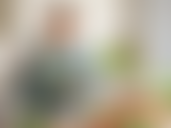 A mature woman eating a healthy vegan salad plate in the kitchen