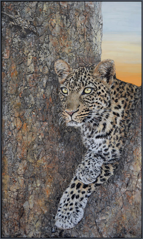 Leopard resting against tree trunk at sunset