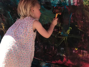 Young girl concentrating on a painting she is working on