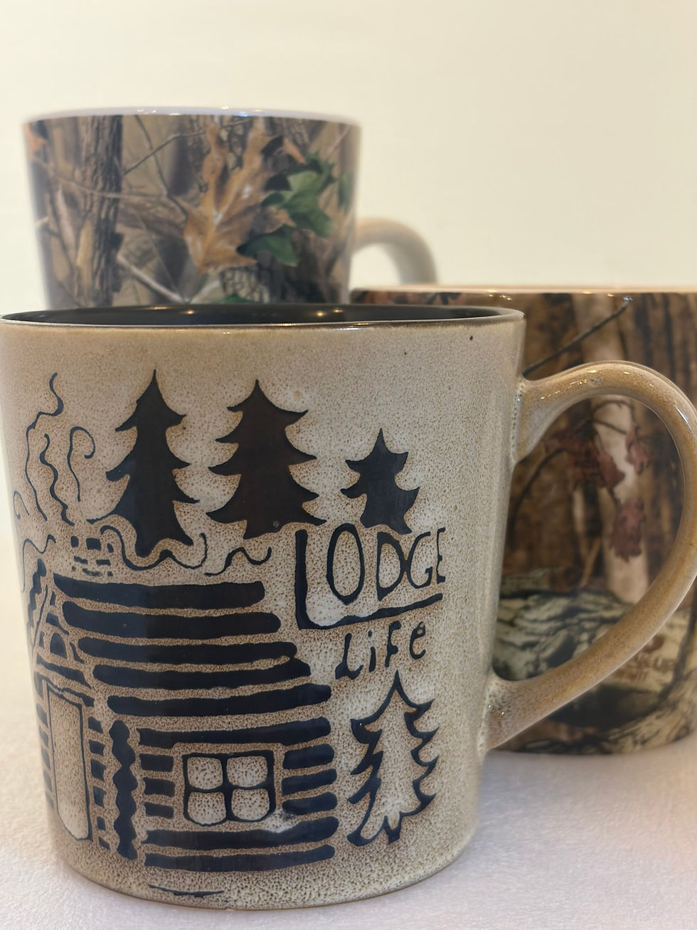 Collection of pre-owned coffee mugs with lodge designs