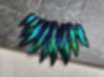 A draped choker of rows of iridescent beetle wingcases