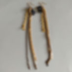 Long earrings made of many different gold, black, and rhinestone chains.