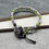 Thumbnail: Bracelet with ceramic focal featuring blueberries, with green and purple seed beads in a woven pattern.
