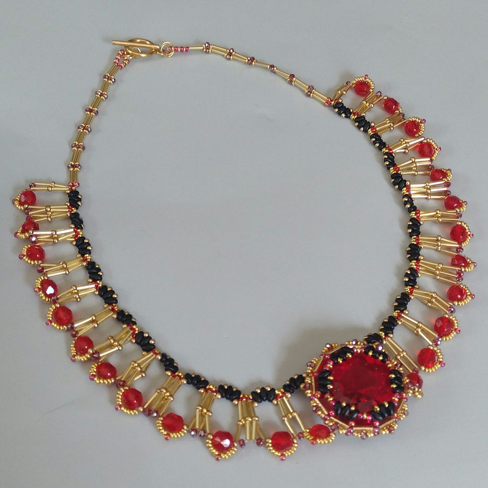 Ornate gold and red beaded colliere with a giant red crystal