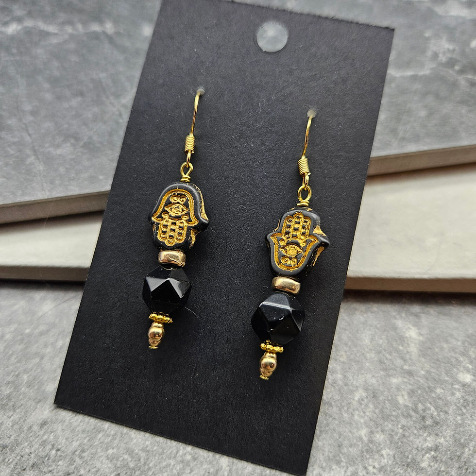 Gold & black earrings with hamsa hands pointing up & down