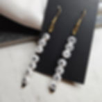 Letter bead earrings that spell out "Fuck Ice" on gold tone ear hooks