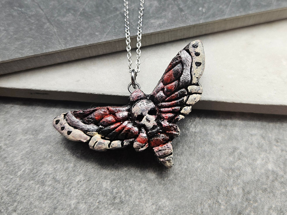 White, black & red death's head moth pendant
