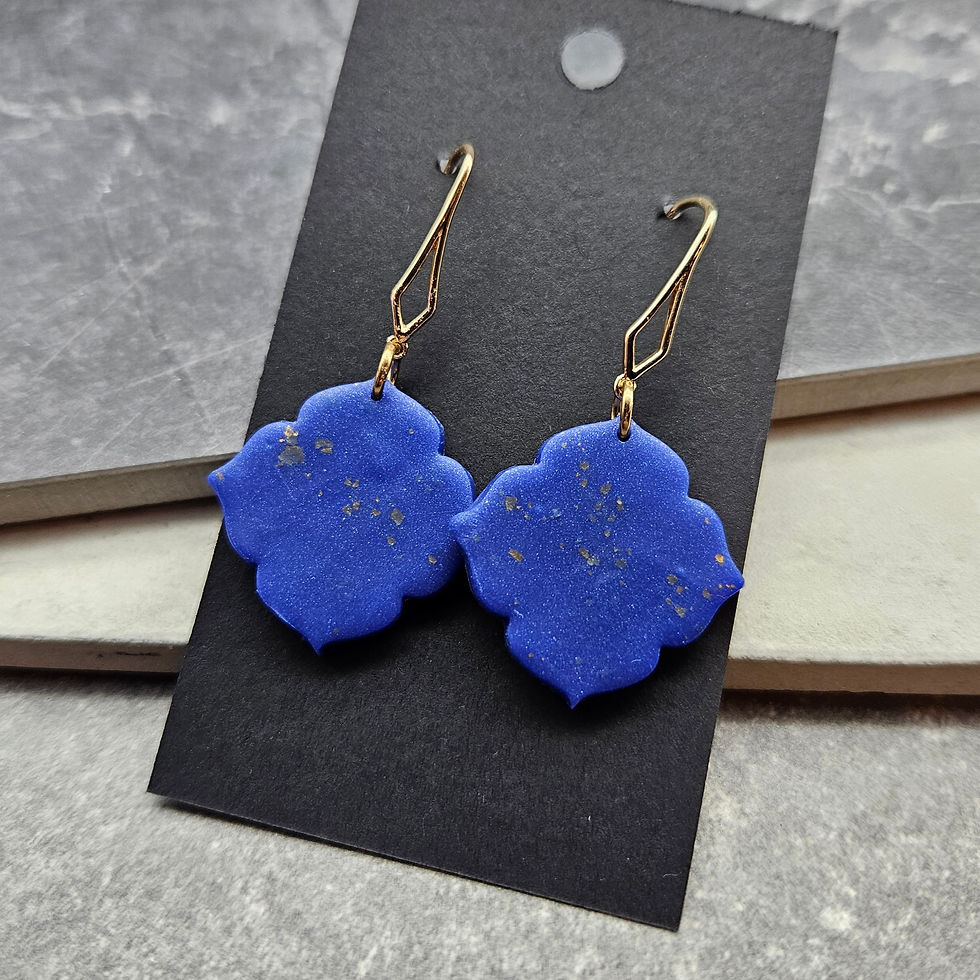 Earrings with deep blue shapes flecked with gold, on gold earwires