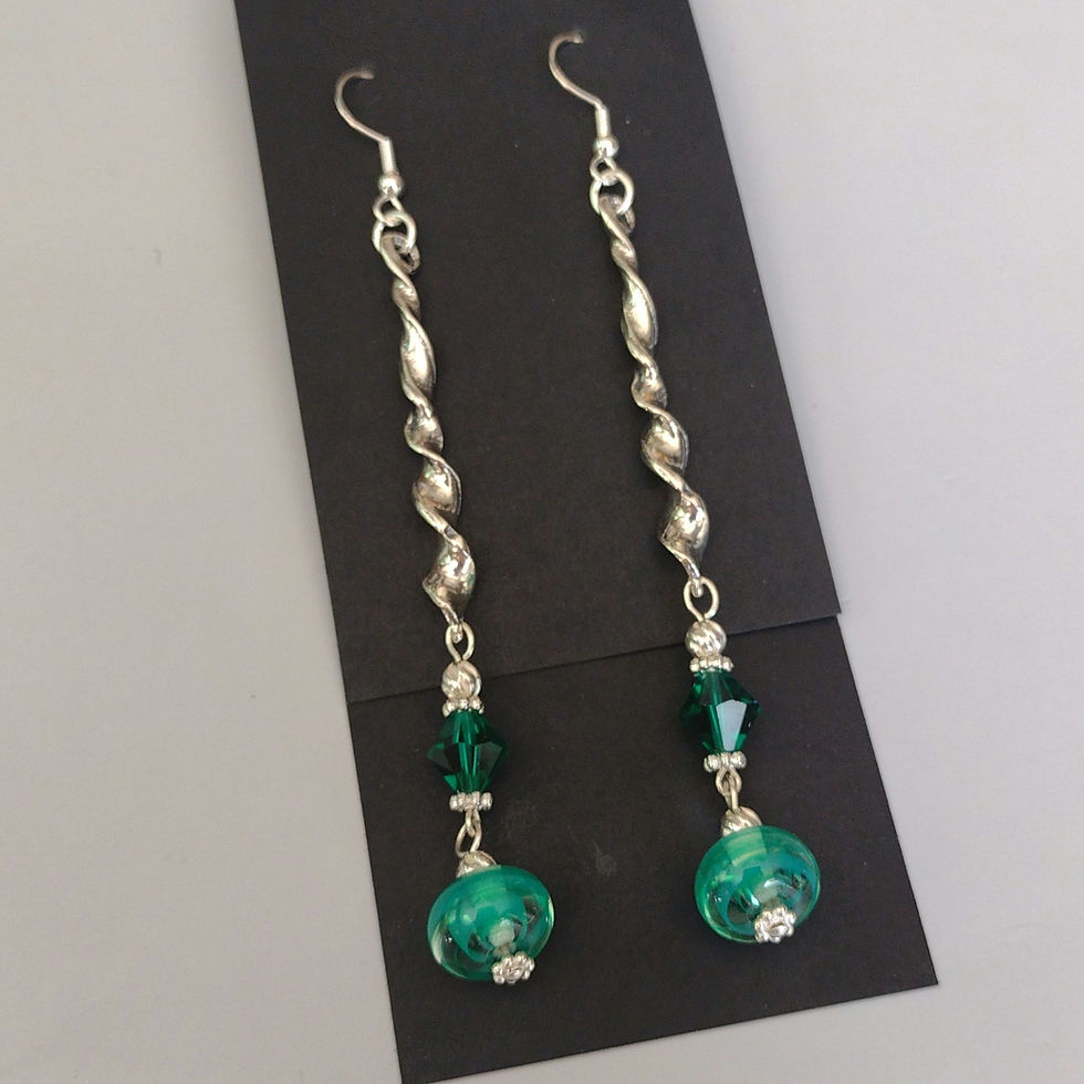 Earrings with sterling silver twists and green Swarovski crystal above green lampwork rondelles