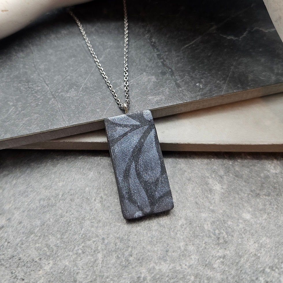 Mica leaf stencil on black rectangle pendant