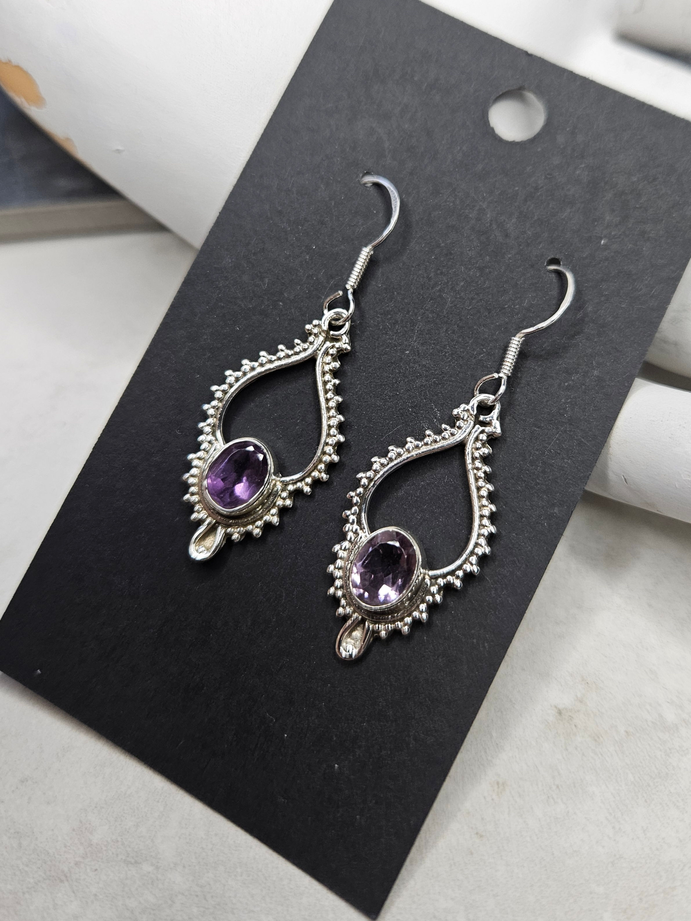 Earrings with amethysts in sterling silver frames.