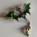 A green and yellow dragon brooch or pendant