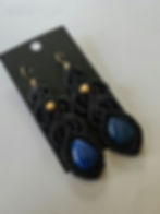 Intricate black macrame earrings set with teardrop blue beads