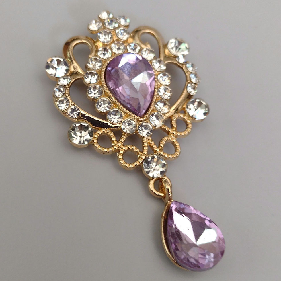 Brooch with purple glass focal and dtop, with crystal accents.