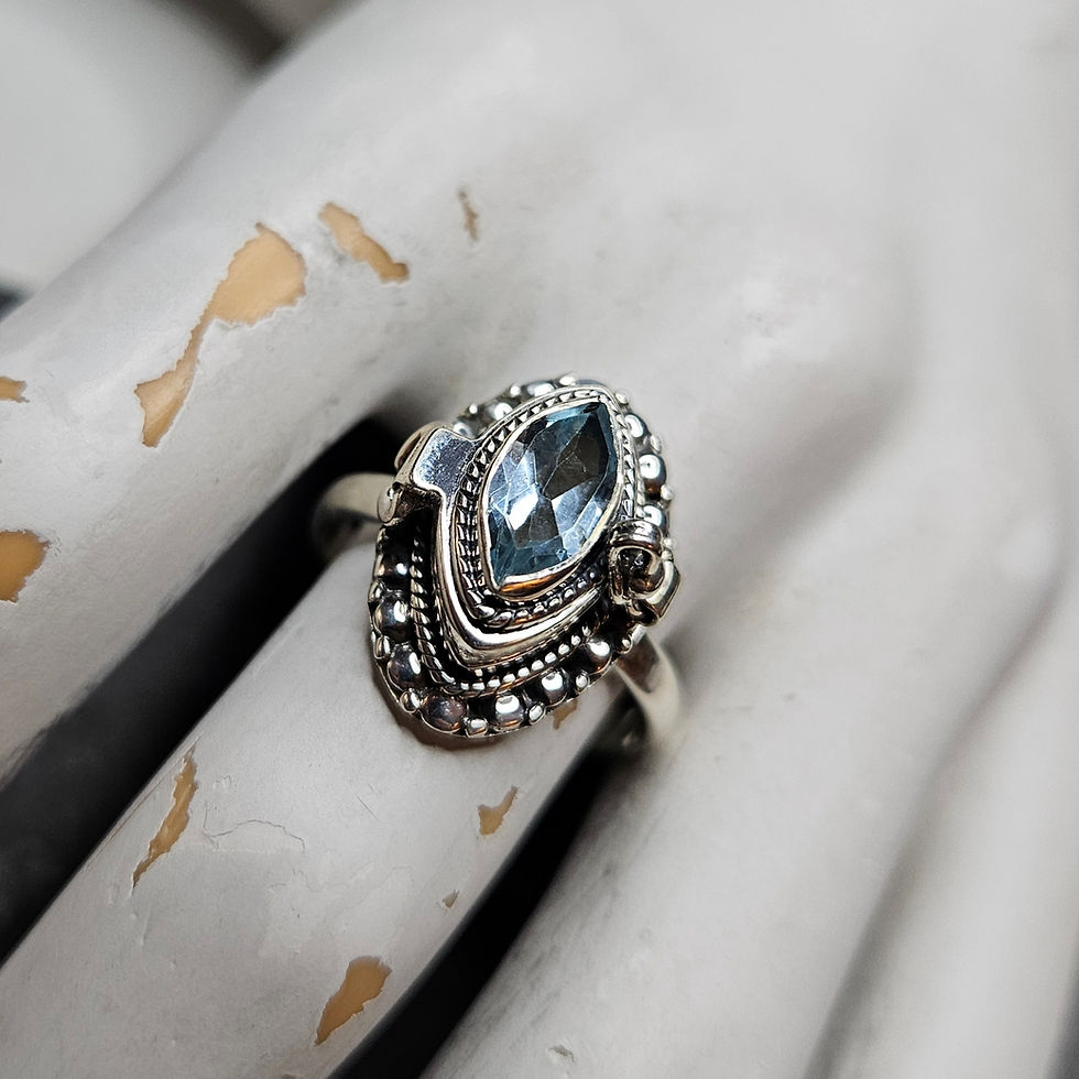 Poison ring with a marquise blue topaz