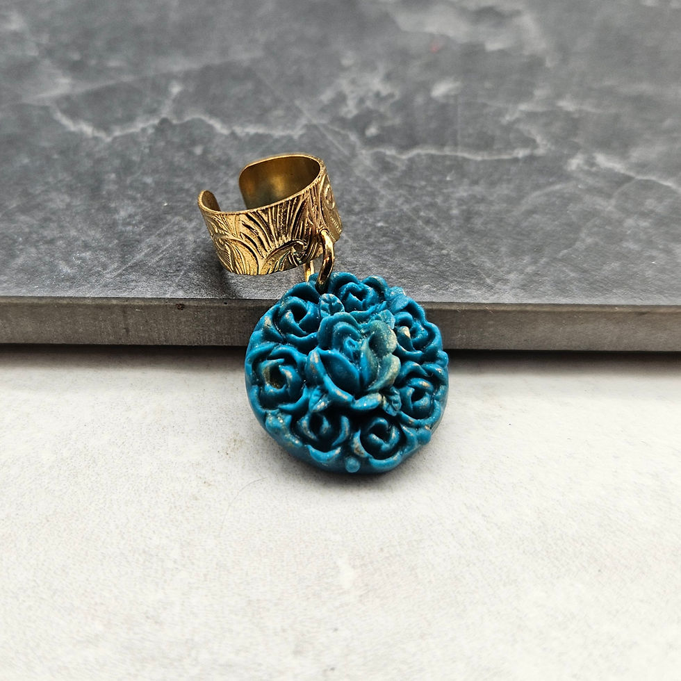 Gold engraved ear cuff with teal and gold speckled floral circle