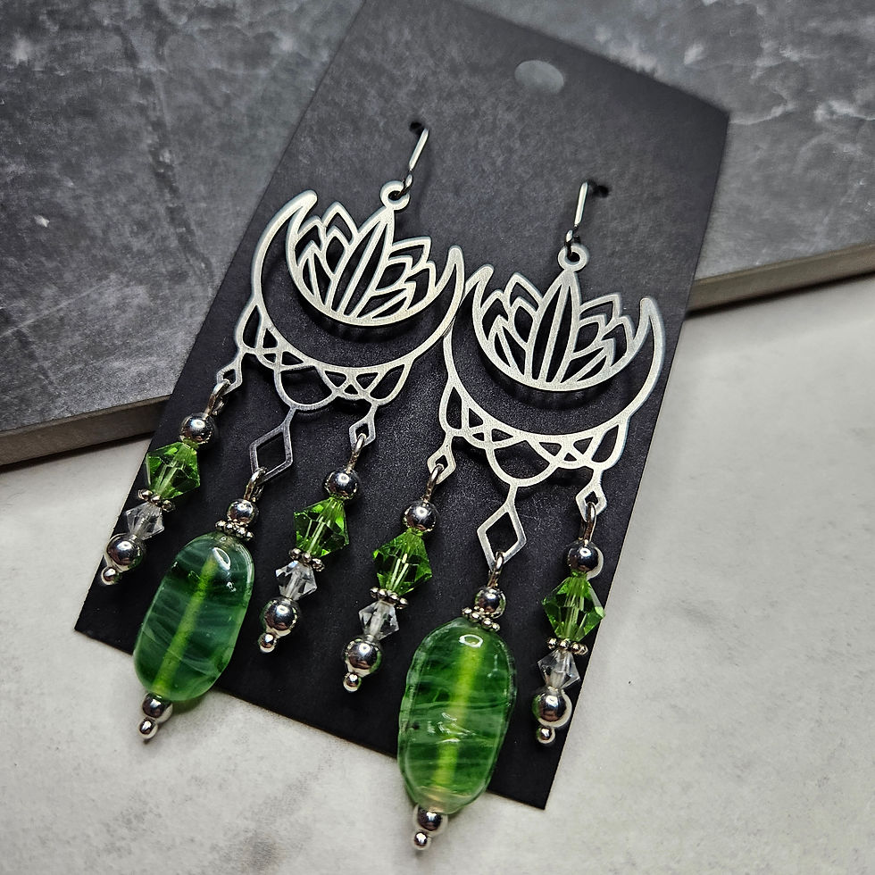 Earrings with stainless steel moon and lotus chandelier connectors with green crystals and lampwork beads.