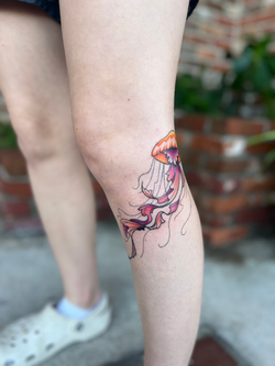 Beautiful Color Jellyfish Tattoo on the knee by Brielle Benefield
