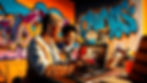 Using this image to create a mentoring scenario between two people in a graffiti room. the