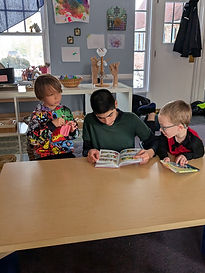 big kid reading to small kids