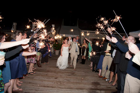 Couple leaves wedding under a sparkler exit.