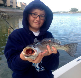 Young boy showing off his fish