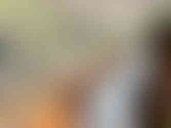 long table setting with white tablecloth and blue and white tall candles setup in the sunroom at Alexander's overlooking the lagoon