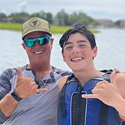 Boy and his father having a good time on a boat