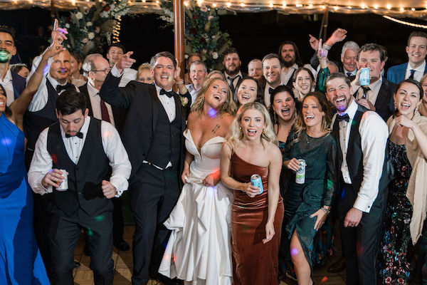 bride and groom dancing surrounded by friends 