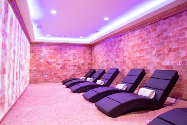 the salt pink room with pink bricks and lounge chairs lining the walls