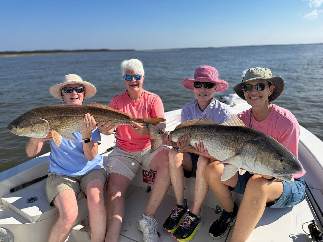 Group of women showing off their catch