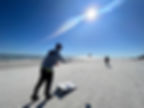 two men playing corn hole on Palmetto Dunes beach