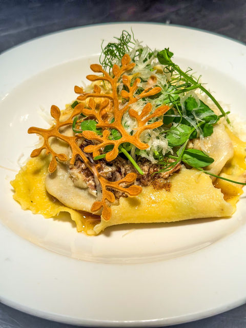plate of braised lamb raviolo