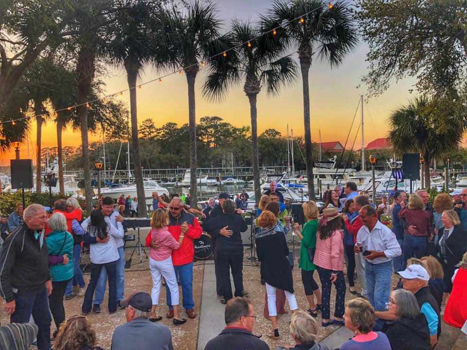 couples dancing with Shelter Cove marina and sunset in background