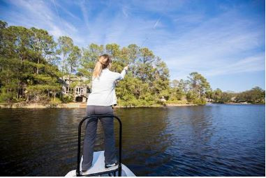 fisherman casting in palmetto dunes lagoon