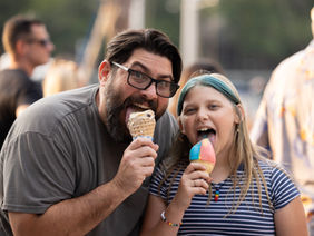 Father and daughter eating ice cream