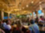 crowd of people dining in the evening
