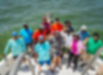 Group of people on party fishing boat in water
