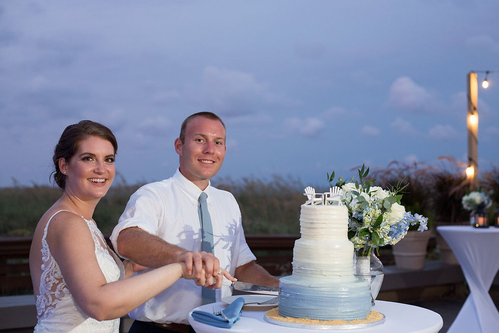 bride and groom cutting wedding cake in the evening