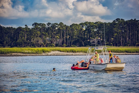 kids in a tube and people in a boat