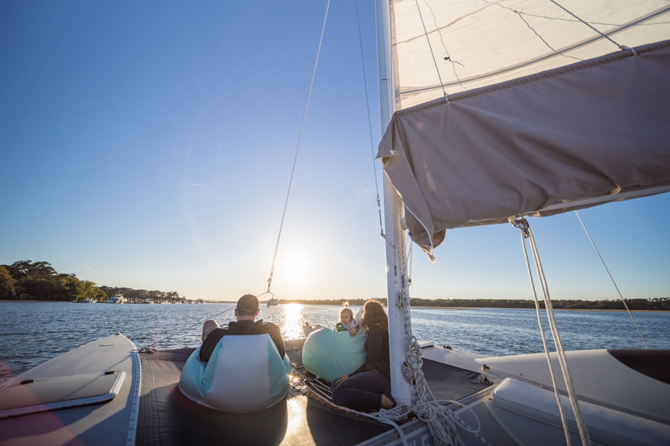 Couple sitting on beanbag chairs enjoying the view while sailing 