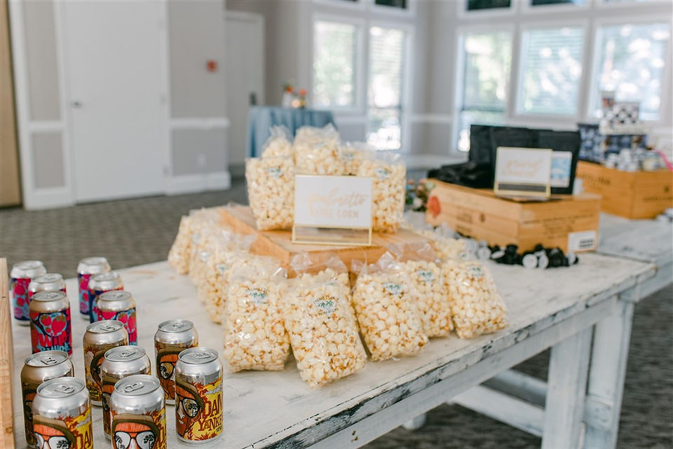 table with beer, popcorn and other goodies for guests to fill their bags