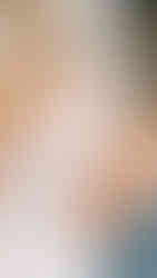 mother of the bride buttoning up the back of the brides dress