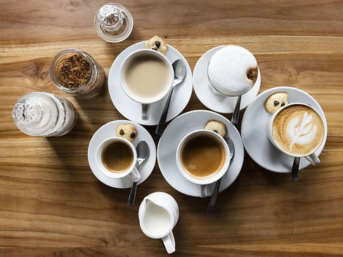 assorted-coffee-cups-on-a-wooden-table.jpg