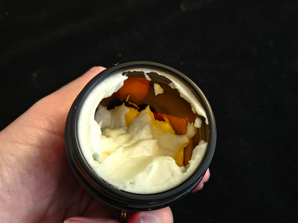 Close-up view of a jar of natural tallow balm with a smooth texture